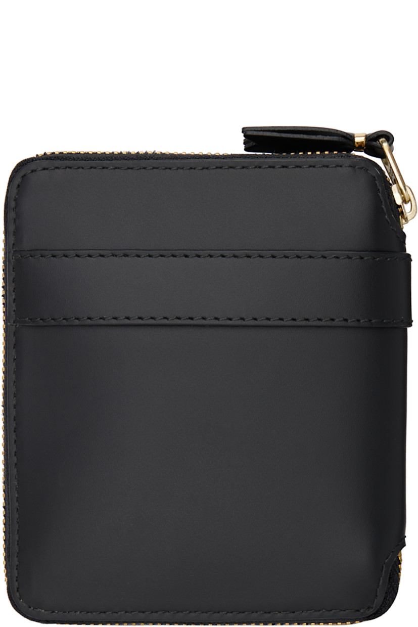 Buffed leather wallet in black.

· Bow accent at face
· Zip closure
· Four card slots at interior
· One patch pocket
· One note slot
· Press-stud coin compartment
· Grained leather lining
· H4.75" x W4.25" x D1"

Supplier color: Black
