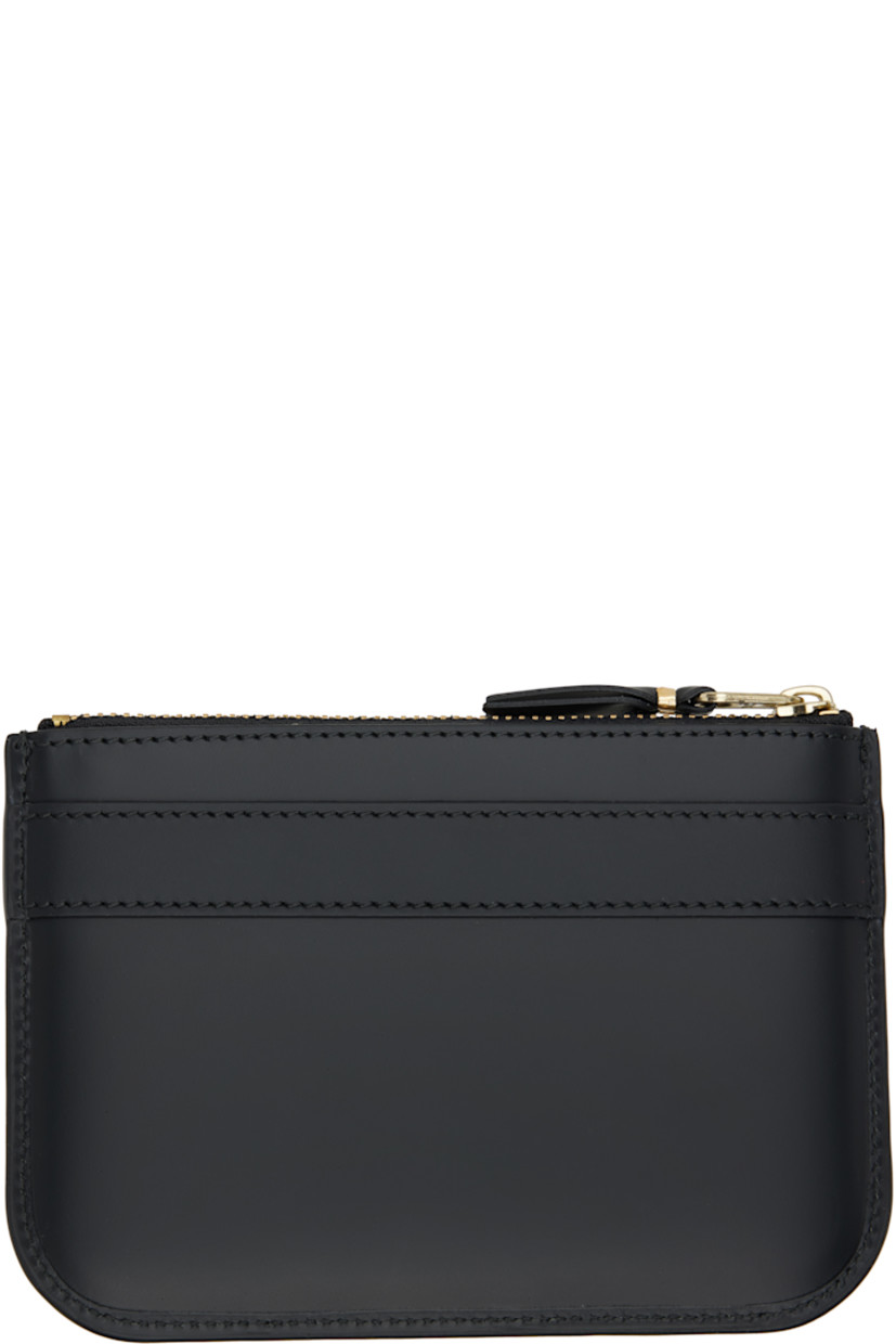 Buffed leather wallet.

· Bow accent and logo stamp at face
· Zip closure
· Grained leather lining 
· H4" x W6"

Supplier color: Black
