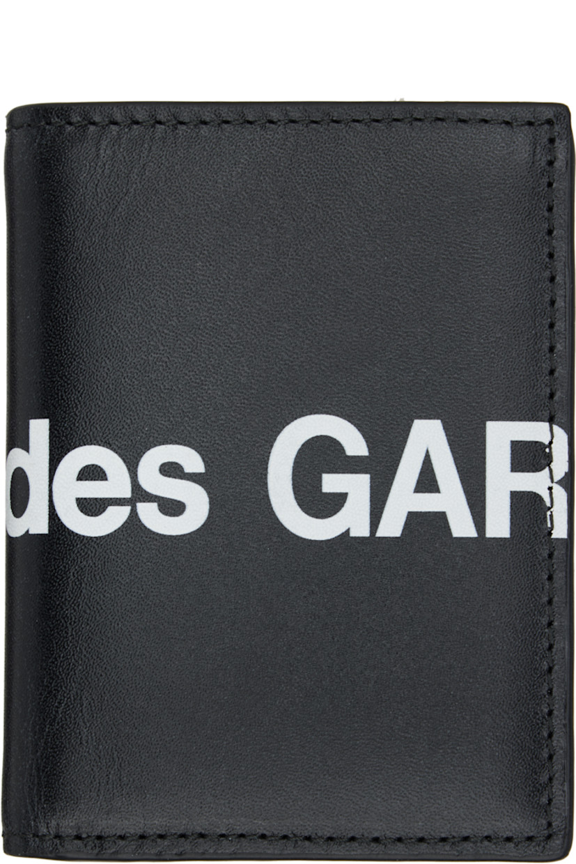 Buffed leather bifold wallet.

· Logo printed throughout
· Six card slots at interior 
· One note slot 
· H4" x W3" x D0.5"

Supplier color: Black