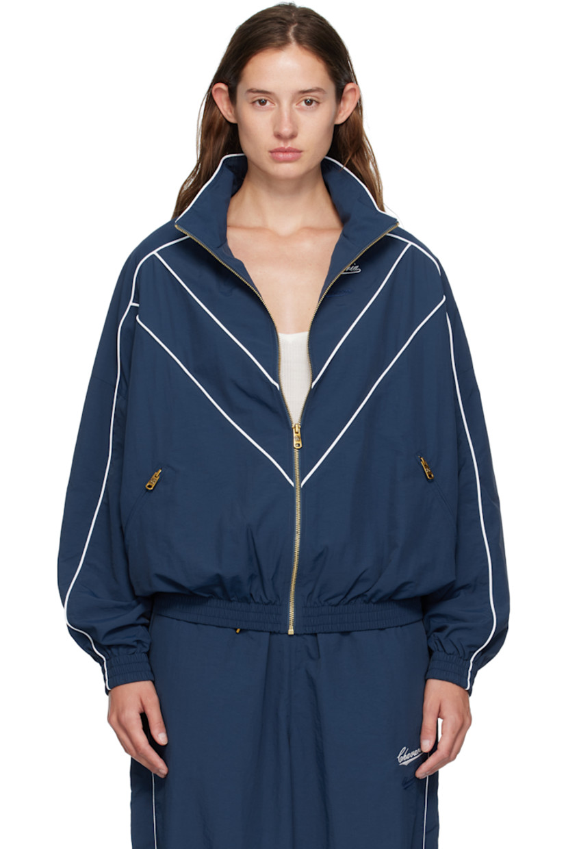 Nylon taffeta track jacket.

· Piping throughout
· Stand collar
· Zip closure
· Logos embroidered at chest
· Zip pockets at waist
· Elasticized hem and cuffs
· Dropped shoulders
· Welt pocket at interior
· Full mesh lining
· Logo-engraved antiqued gold-tone hardware

Supplier color: Prussian blue