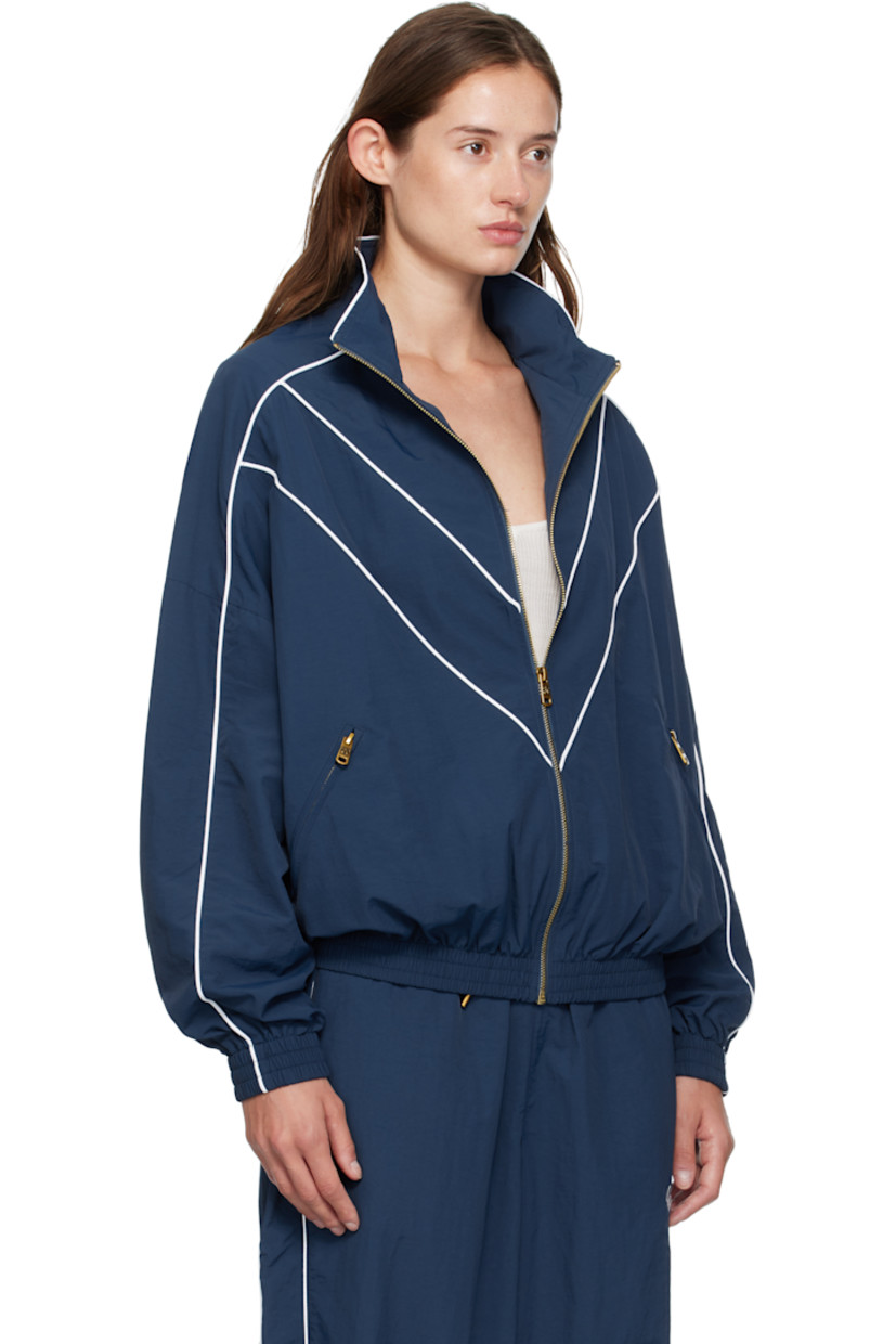 Nylon taffeta track jacket.

· Piping throughout
· Stand collar
· Zip closure
· Logos embroidered at chest
· Zip pockets at waist
· Elasticized hem and cuffs
· Dropped shoulders
· Welt pocket at interior
· Full mesh lining
· Logo-engraved antiqued gold-tone hardware

Supplier color: Prussian blue