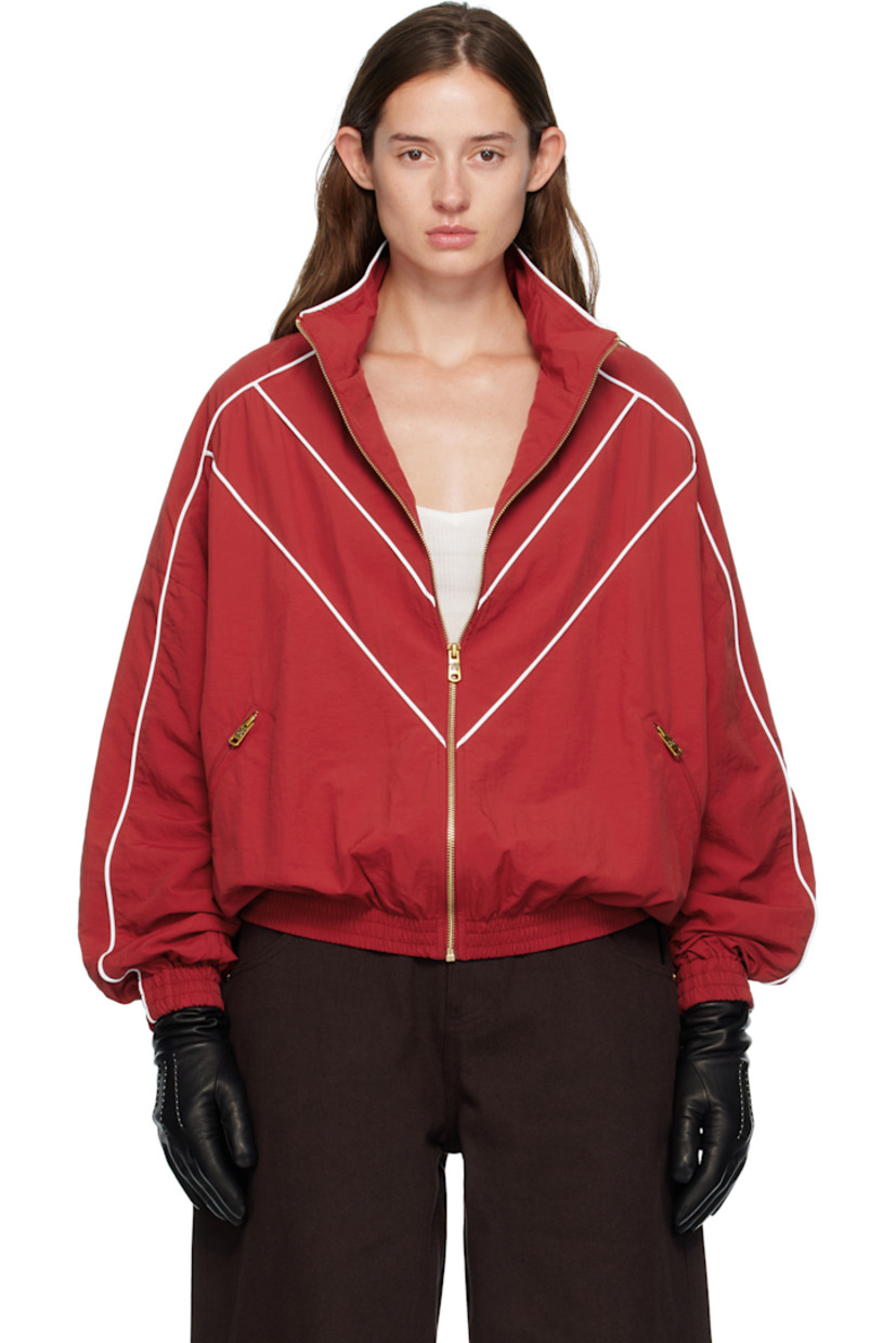 Nylon taffeta track jacket.

· Piping throughout
· Stand collar
· Zip closure
· Logos embroidered at chest
· Zip pockets at waist
· Elasticized hem and cuffs
· Dropped shoulders
· Welt pocket at interior
· Full mesh lining
· Logo-engraved antiqued gold-tone hardware

Supplier color: Red