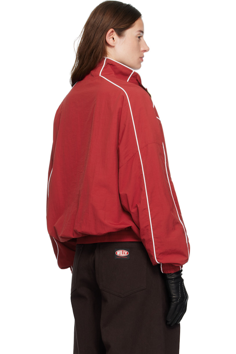 Nylon taffeta track jacket.

· Piping throughout
· Stand collar
· Zip closure
· Logos embroidered at chest
· Zip pockets at waist
· Elasticized hem and cuffs
· Dropped shoulders
· Welt pocket at interior
· Full mesh lining
· Logo-engraved antiqued gold-tone hardware

Supplier color: Red