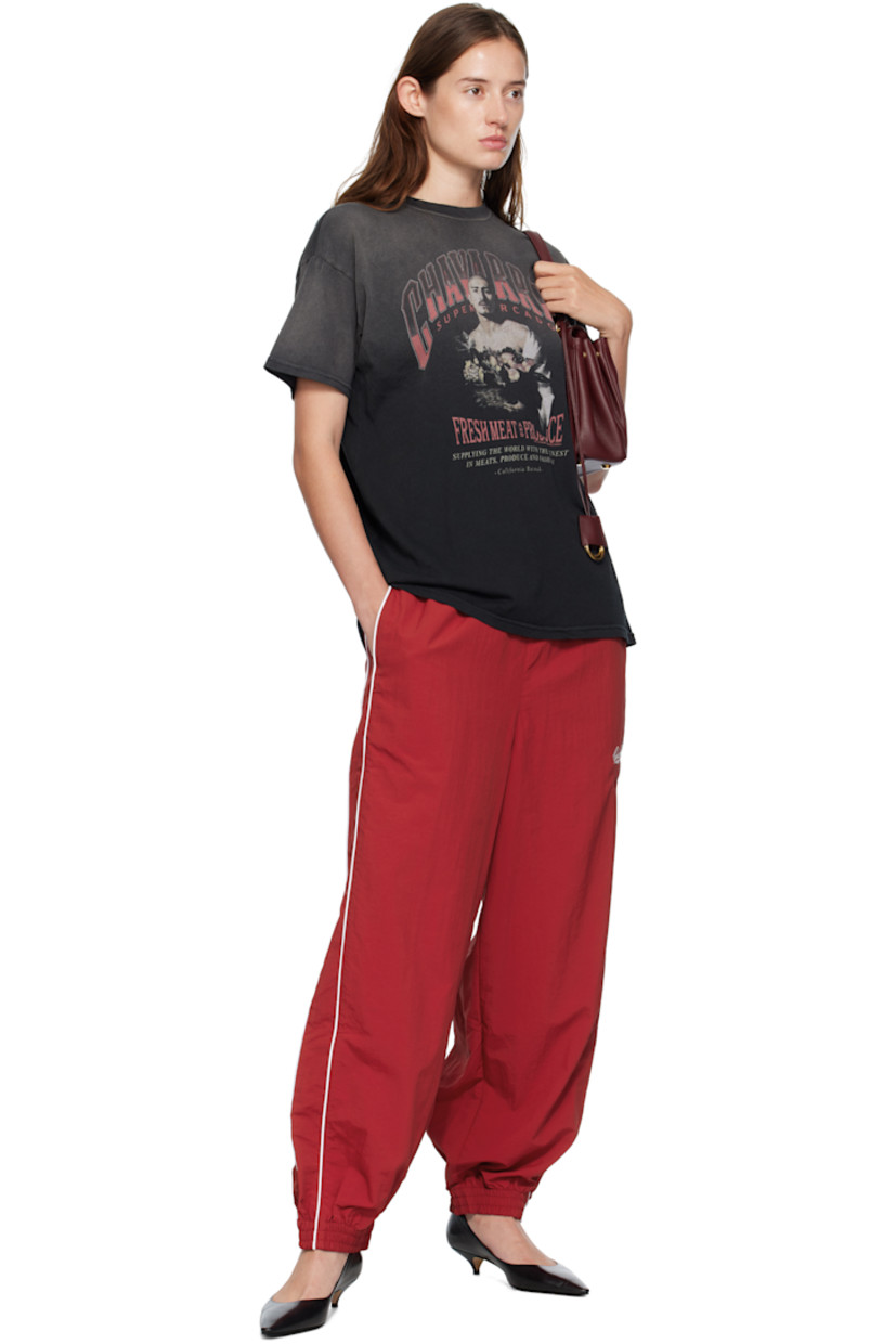 Lightweight nylon taffeta track pants.

· Loose-fit
· Concealed drawstring at elasticized waistband
· Two-pocket styling
· Logos embroidered at front
· Elasticized cuffs
· Piping at outseams
· Dropped inseam

Supplier color: Red
