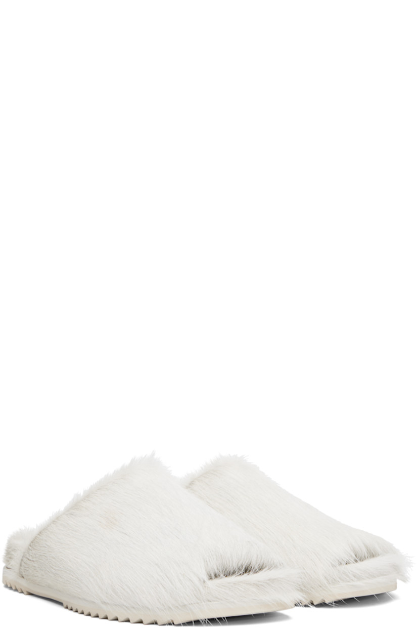 Hair-on leather slip-on sandals.

· Open toe
· Treaded rubber sole

Supplier color: Milk