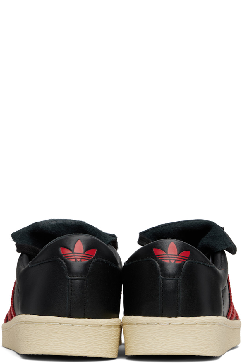 Buffed leather sneakers.

· Rubber cap toe
· Lace-up closure
· Logo patch at foldover tongue
· Padded collar
· Perforations and signature serrated stripes at sides
· Text stamp at outer side
· Leather lining
· Logo stamp at heel tab
· Rubber sole 

Part of the Willy Chavarria x adidas Originals collaboration.

Supplier color: Core black/Core black/Red