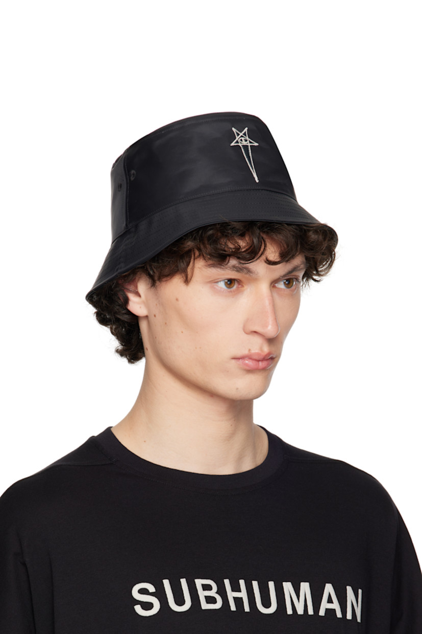 Nylon satin bucket hat in black.

· Embroidered eyelets at crown
· Embroidered logo patch at face
· Grosgrain browband
· Plain-woven cotton lining 

Part of the Rick Owens x Champion collaboration.

Supplier color: Black