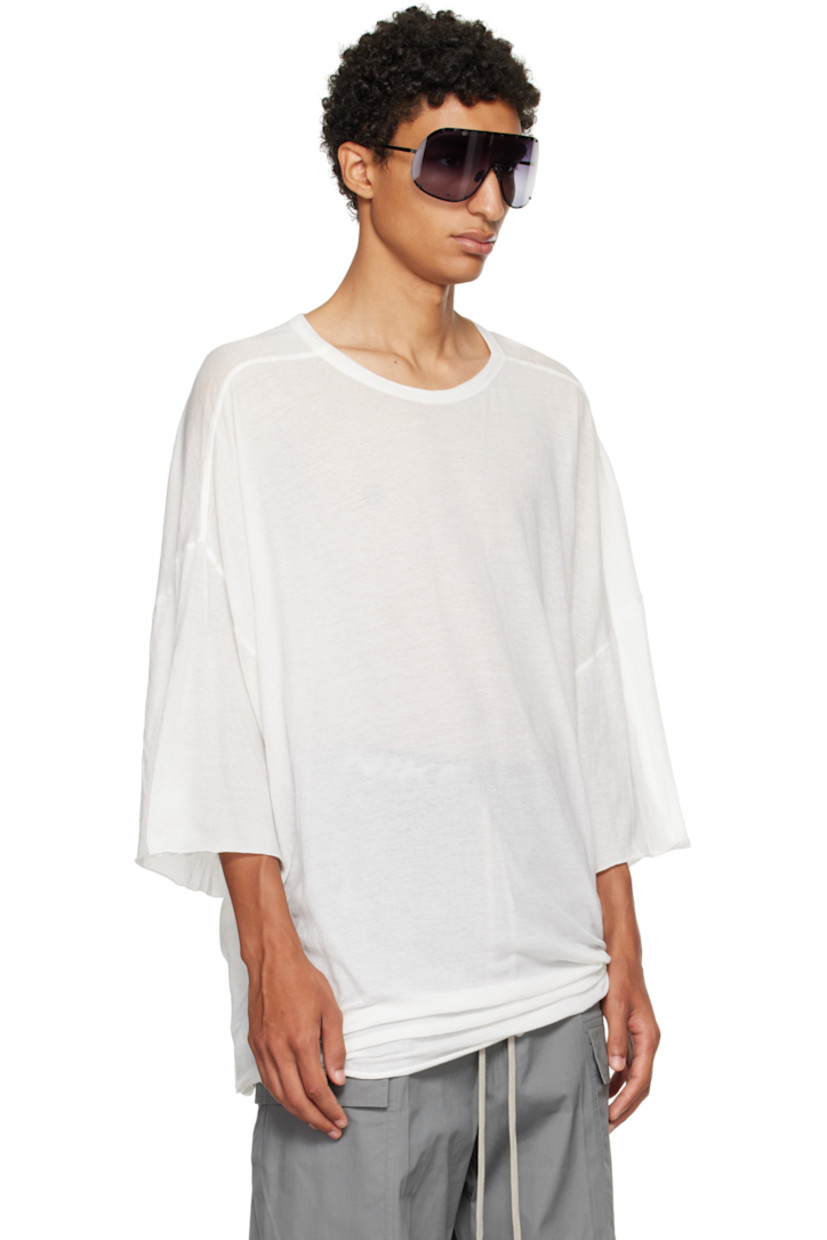 Semi-sheer organic cotton jersey T-shirt.

· GOTS-certified organic cotton
· Rib-knit crewneck
· Raw edge at hem and cuffs
· Twisted side seams
· Offset seam at dropped shoulders

Supplier color: Milk
