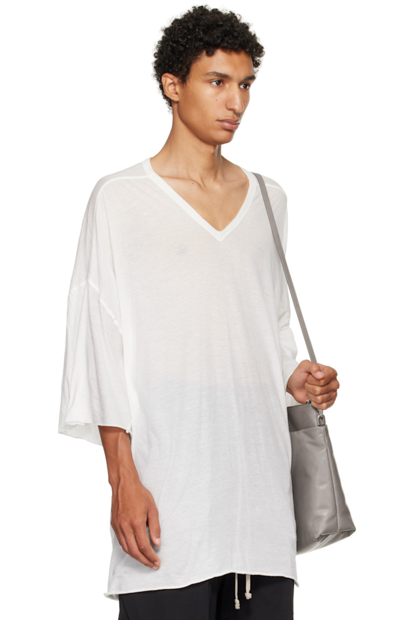 Semi-sheer organic cotton jersey T-shirt.

· GOTS-certified organic cotton
· Rib-knit V-neck
· Raw edge at hem and cuffs
· Twisted side seams
· Offset seam at dropped shoulders

Supplier color: Milk