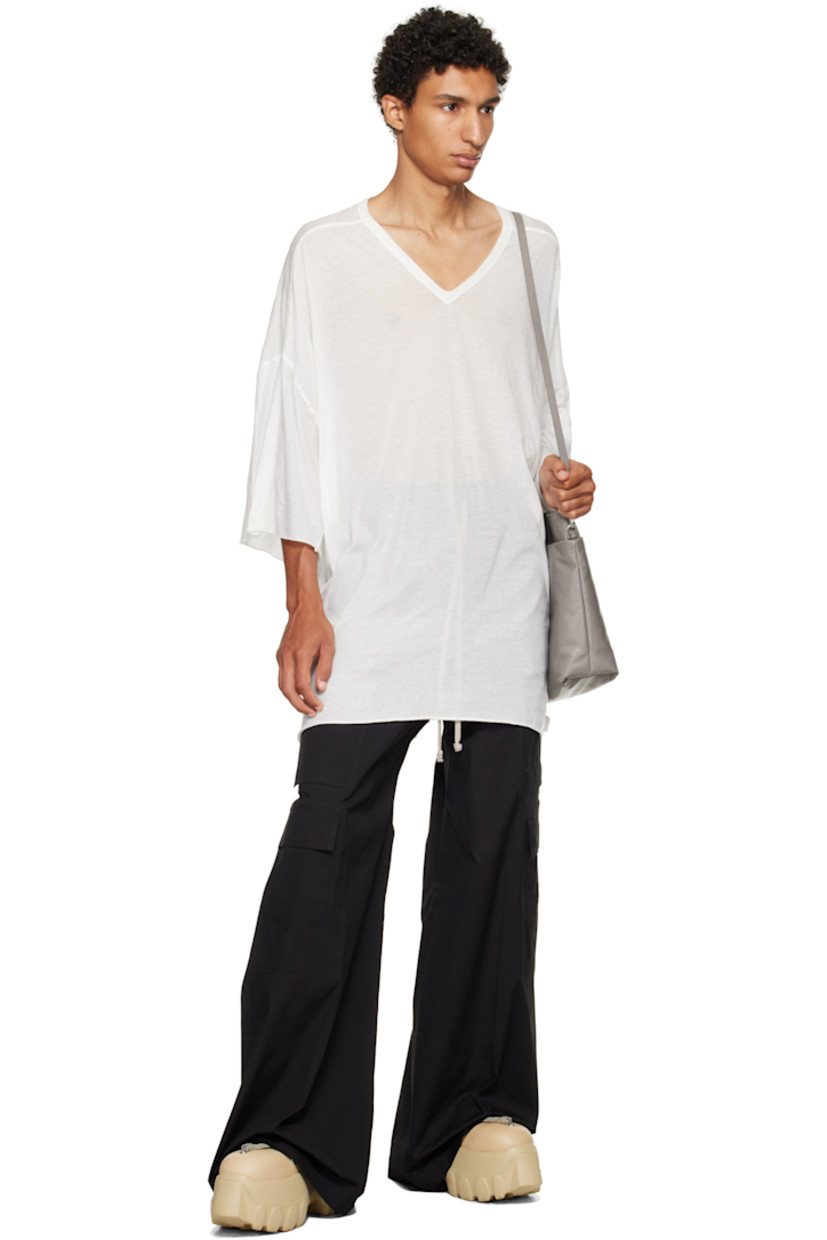Semi-sheer organic cotton jersey T-shirt.

· GOTS-certified organic cotton
· Rib-knit V-neck
· Raw edge at hem and cuffs
· Twisted side seams
· Offset seam at dropped shoulders

Supplier color: Milk