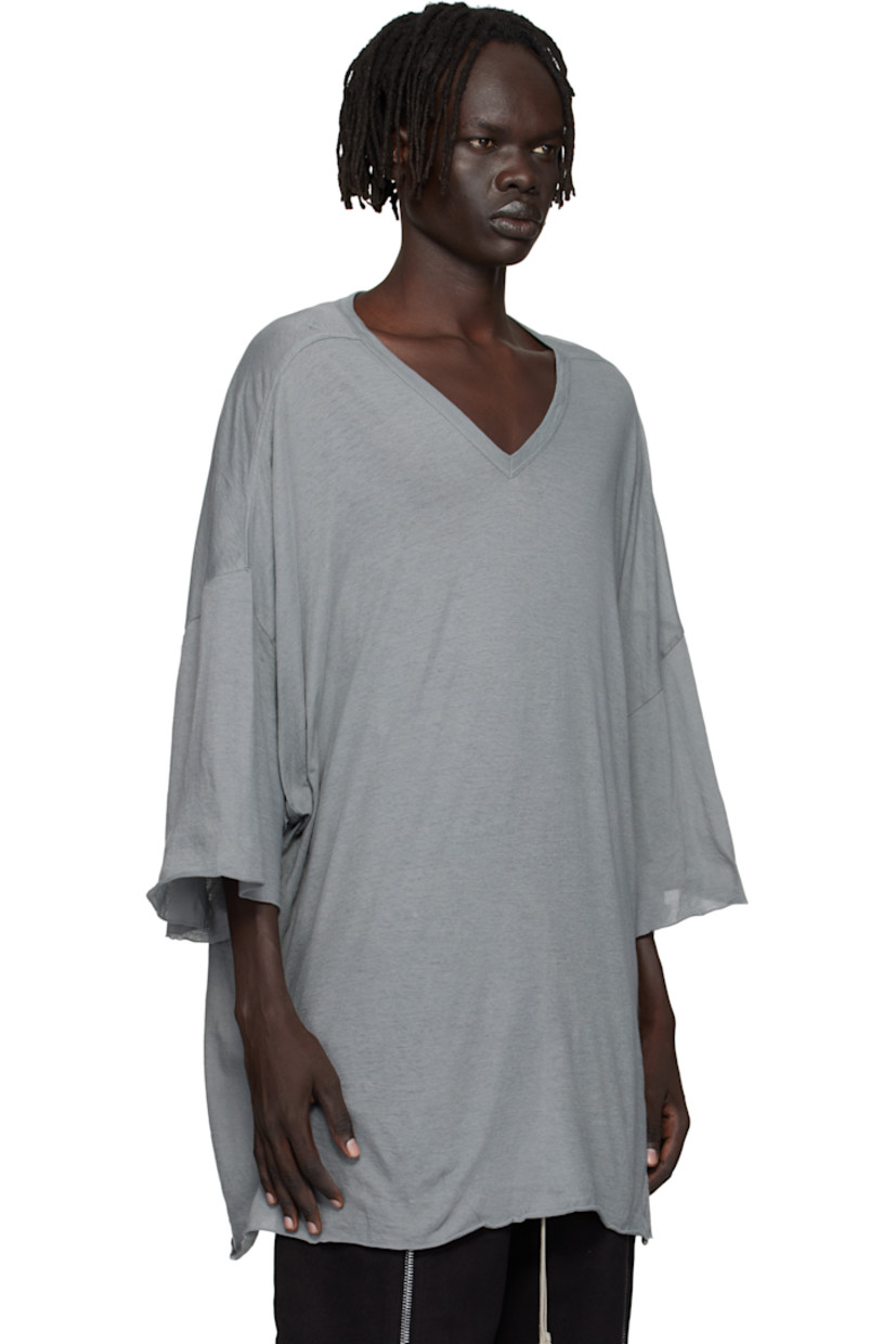 Semi-sheer organic cotton jersey T-shirt.

· GOTS-certified organic cotton
· Rib-knit V-neck
· Raw edge at hem and cuffs
· Twisted side seams
· Offset seam at dropped shoulders

Supplier color: Washed indigo