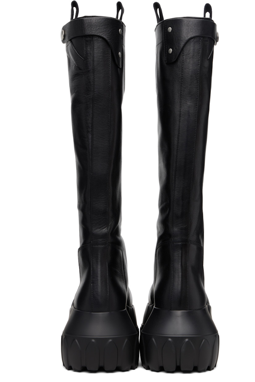 Knee-high vegetable-tanned grained calfskin boots.

· LWG-certified calfskin
· Pull-loops and adjustable press-stud tab at collar
· Calfskin suede lining
· Treaded rubber platform sole
· Platform: H3"

Supplier color: Black