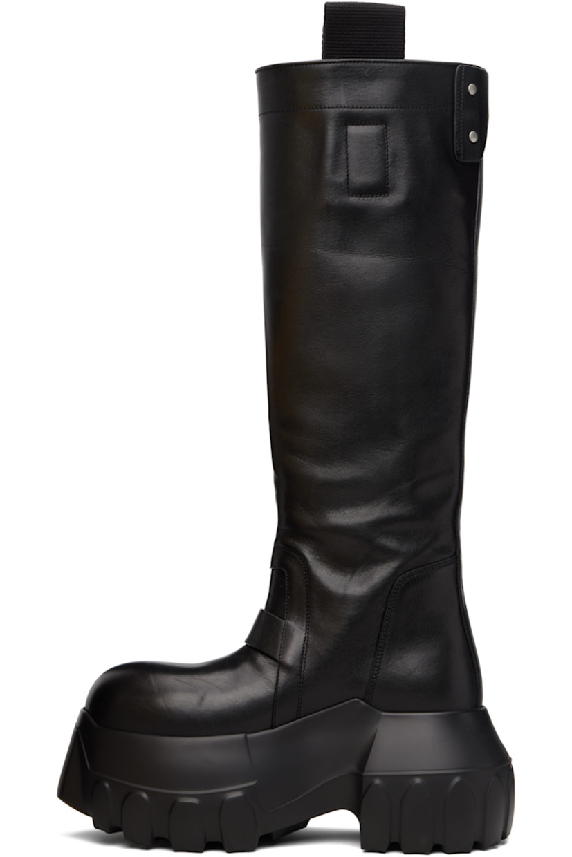 Knee-high vegetable-tanned grained calfskin boots.

· LWG-certified calfskin
· Pull-loops and adjustable press-stud tab at collar
· Calfskin suede lining
· Treaded rubber platform sole
· Platform: H3"

Supplier color: Black