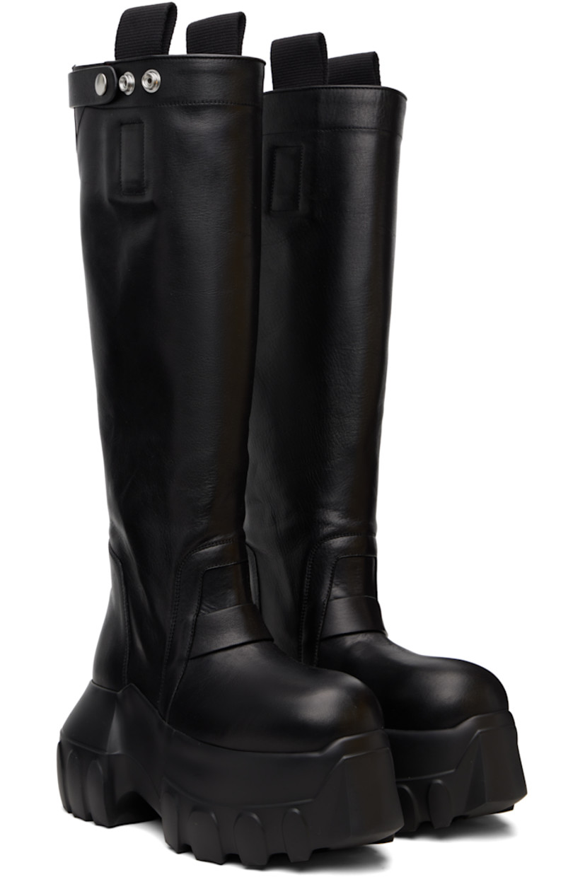 Knee-high vegetable-tanned grained calfskin boots.

· LWG-certified calfskin
· Pull-loops and adjustable press-stud tab at collar
· Calfskin suede lining
· Treaded rubber platform sole
· Platform: H3"

Supplier color: Black