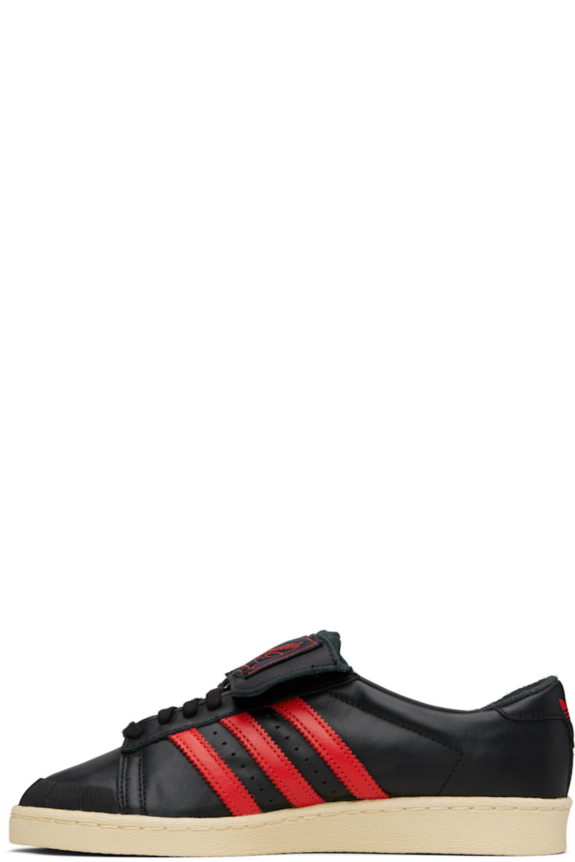 Low-top buffed leather sneakers.

· Textured rubber trim at toe
· Lace-up closure
· Logo patch at extended foldover tongue
· Padded collar
· Signature serrated stripes and perforations at sides
· Text embossed at outer side
· Logo embossed at heel tab
· Buffed leather lining
· Treaded rubber sole

Part of the Willy Chavarria x adidas Originals collaboration.

Supplier color: Black/Red