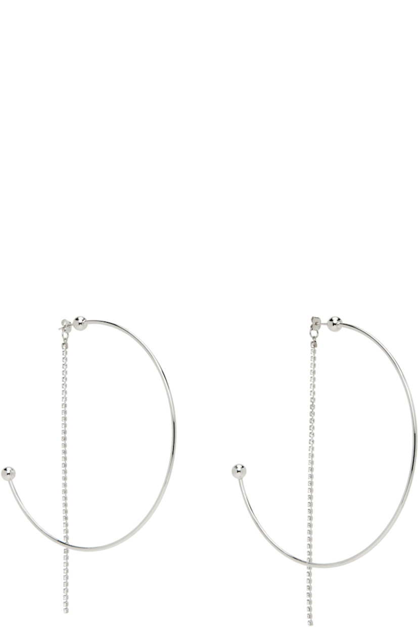 Pair of handcrafted open hoop earrings in palladium-plated brass.

· Cup chain with crystals at fastening 
· Post-stud fastening 
· D4"

Supplier color: Palladium