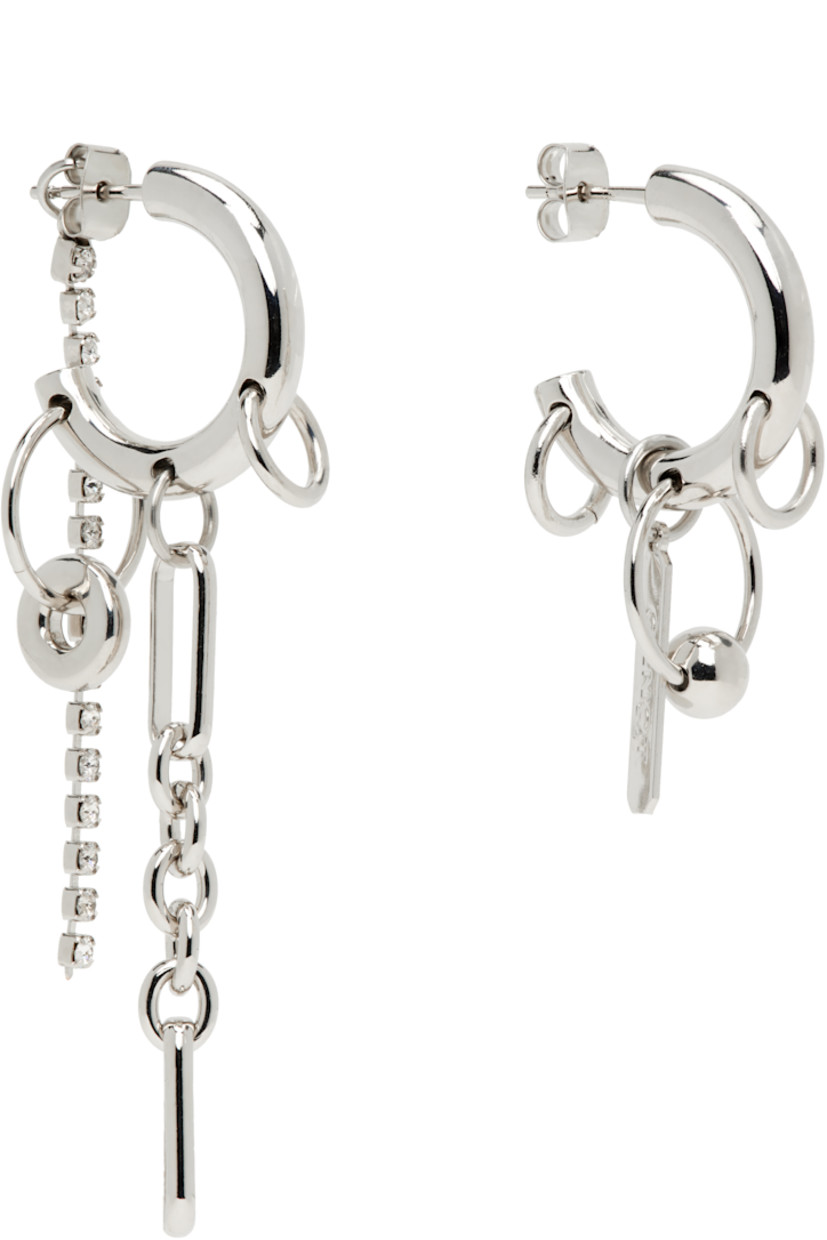 Pair of handcrafted mismatched open hoop earrings in palladium-plated brass.

· Charms, crystal cup chain, and cable chain at single drop
· Charms and logo plaque at single drop
· Post-stud fastening
· H2.75" x W0.75"; H1.5" x W0.75"

Supplier color: Palladium