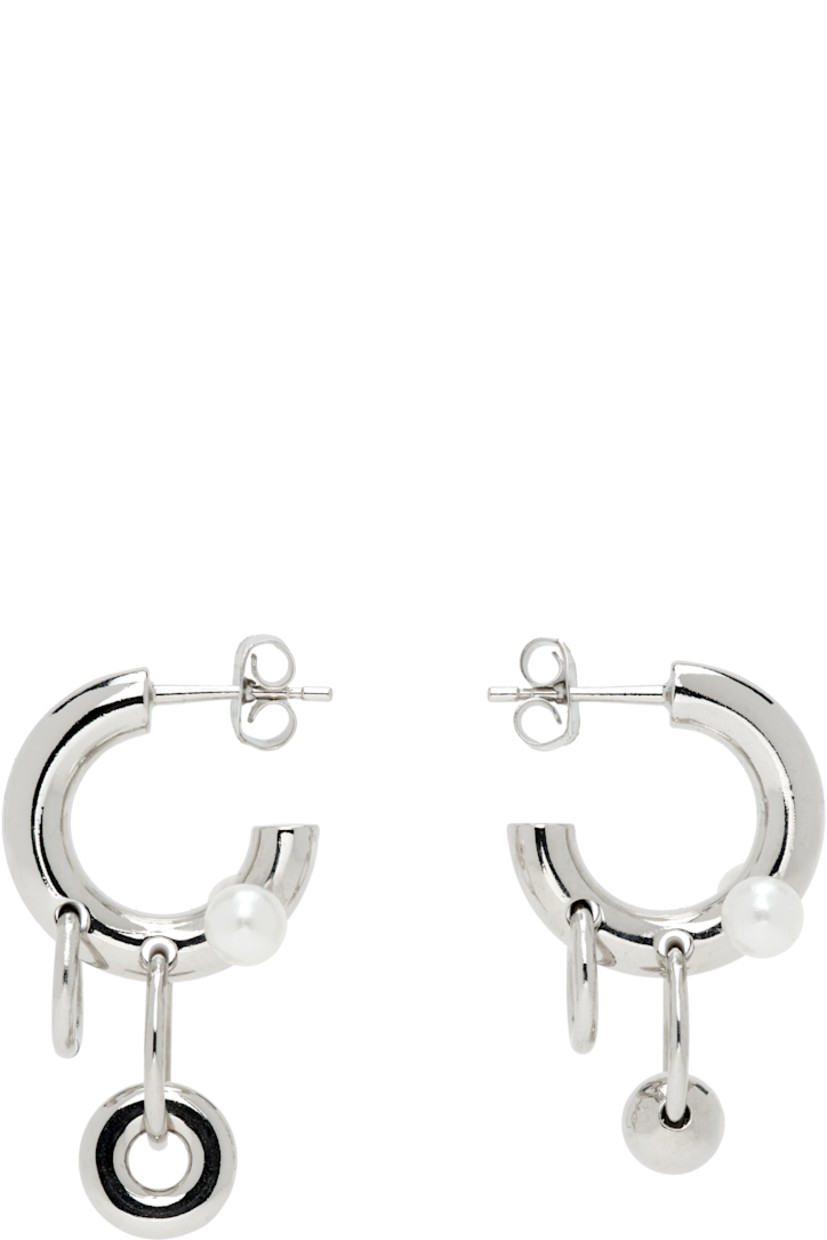 Pair of handcrafted mismatched open hoop earrings in palladium-plated brass.

· Pearls and charms at hoop
· Post-stud fastening
· D0.5"

Supplier color: Palladium