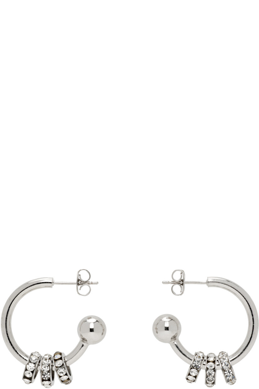 Pair of handcrafted open hoop earrings in palladium-plated brass.

· Charms with channel-set crystals at drop
· Post-stud fastening
· D1"

Supplier color: Black