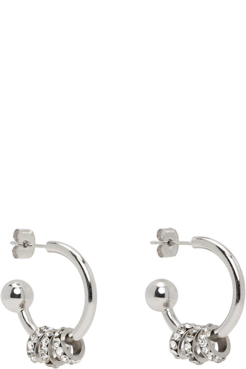Pair of handcrafted open hoop earrings in palladium-plated brass.

· Charms with channel-set crystals at drop
· Post-stud fastening
· D1"

Supplier color: Black