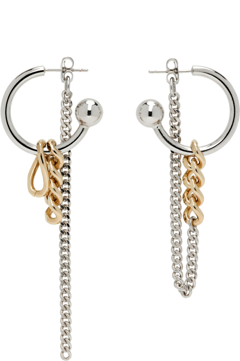 Pair of handcrafted mismatched drop earrings in 24k gold- and palladium-plated brass.

· Charms and curb chain at drop 
· Post-stud fastening 
· H3" x W1"; H2" x W1"

Supplier color: Gold/Palladium