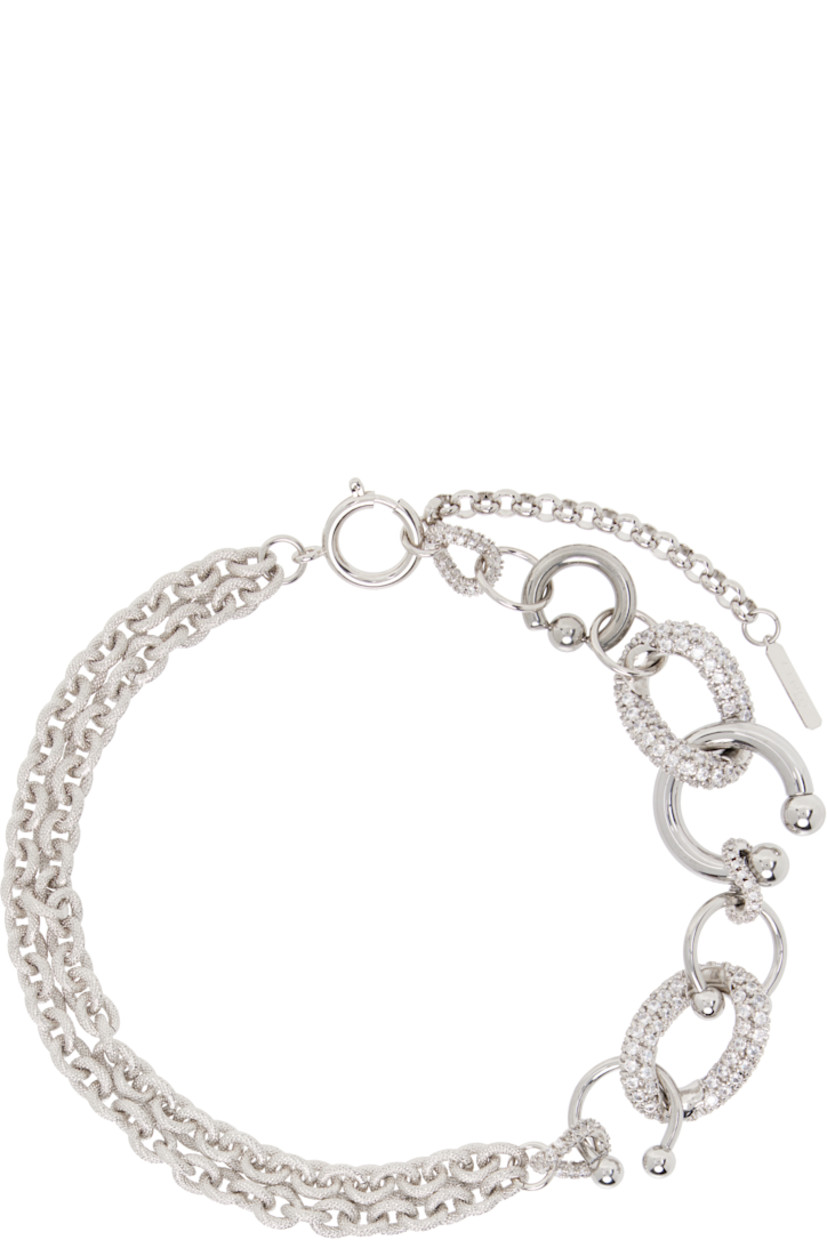 Handcrafted tiered cable chain choker in palladium-plated brass.

· Textured detailing and pavé-set crystals throughout
· Charms at length
· Logo plaque at adjustable spring-ring fastening
· L18"

Supplier color: Palladium