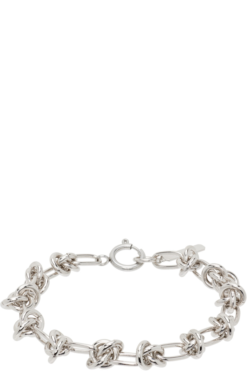 Handcrafted modified cable chain bracelet in palladium-plated brass.

· O-rings throughout
· Logo plaque at spring-ring fastening
· L7.5"

Supplier color: Palladium