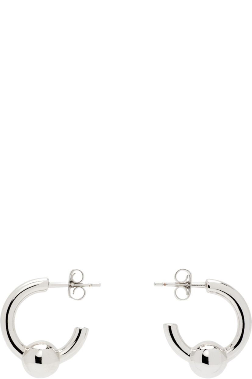 Pair of handcrafted open hoop earrings in palladium-plated brass.

· Post-stud fastening 
· D0.5"

Supplier color: Palladium