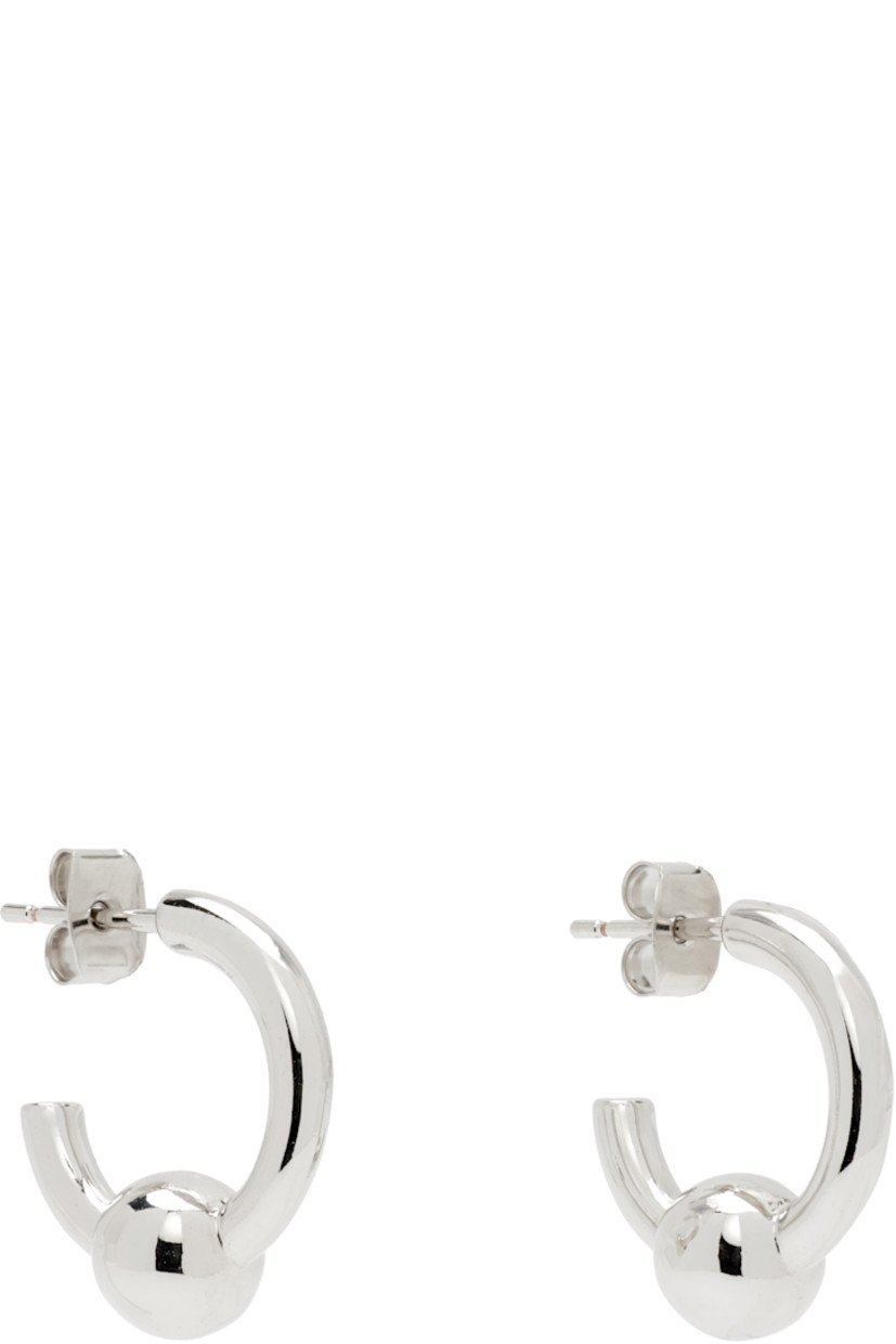 Pair of handcrafted open hoop earrings in palladium-plated brass.

· Post-stud fastening 
· D0.5"

Supplier color: Palladium