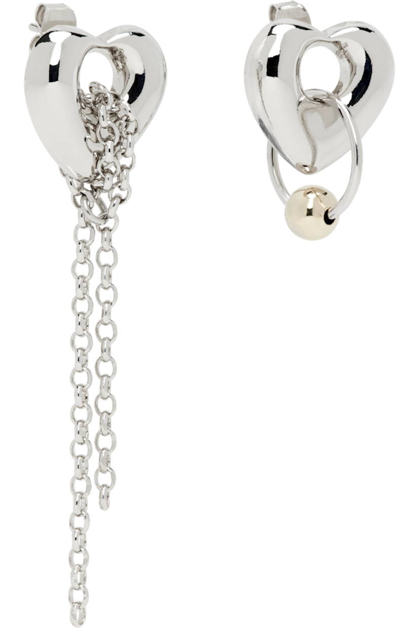 Pair of handcrafted mismatched stud earrings in palladium-plated brass.

· Charm at face 
· Cable chain at drop 
· Post-stud fastening 
· H2" x W0.5"; H0.5" x W0.5"

Supplier color: Palladium