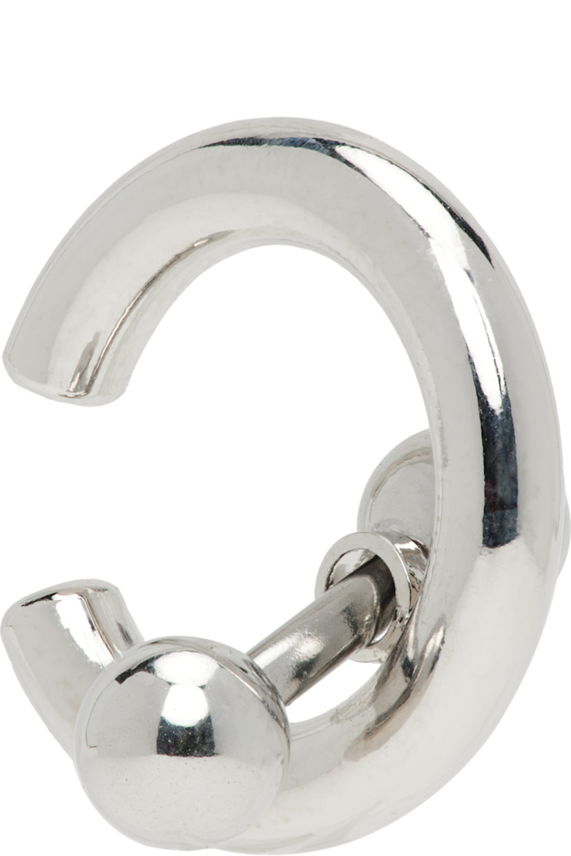 Handcrafted single ear cuff in in palladium-plated brass.

· Charms at drop 
· H0.5" x W0.5"

Supplier color: Palladium