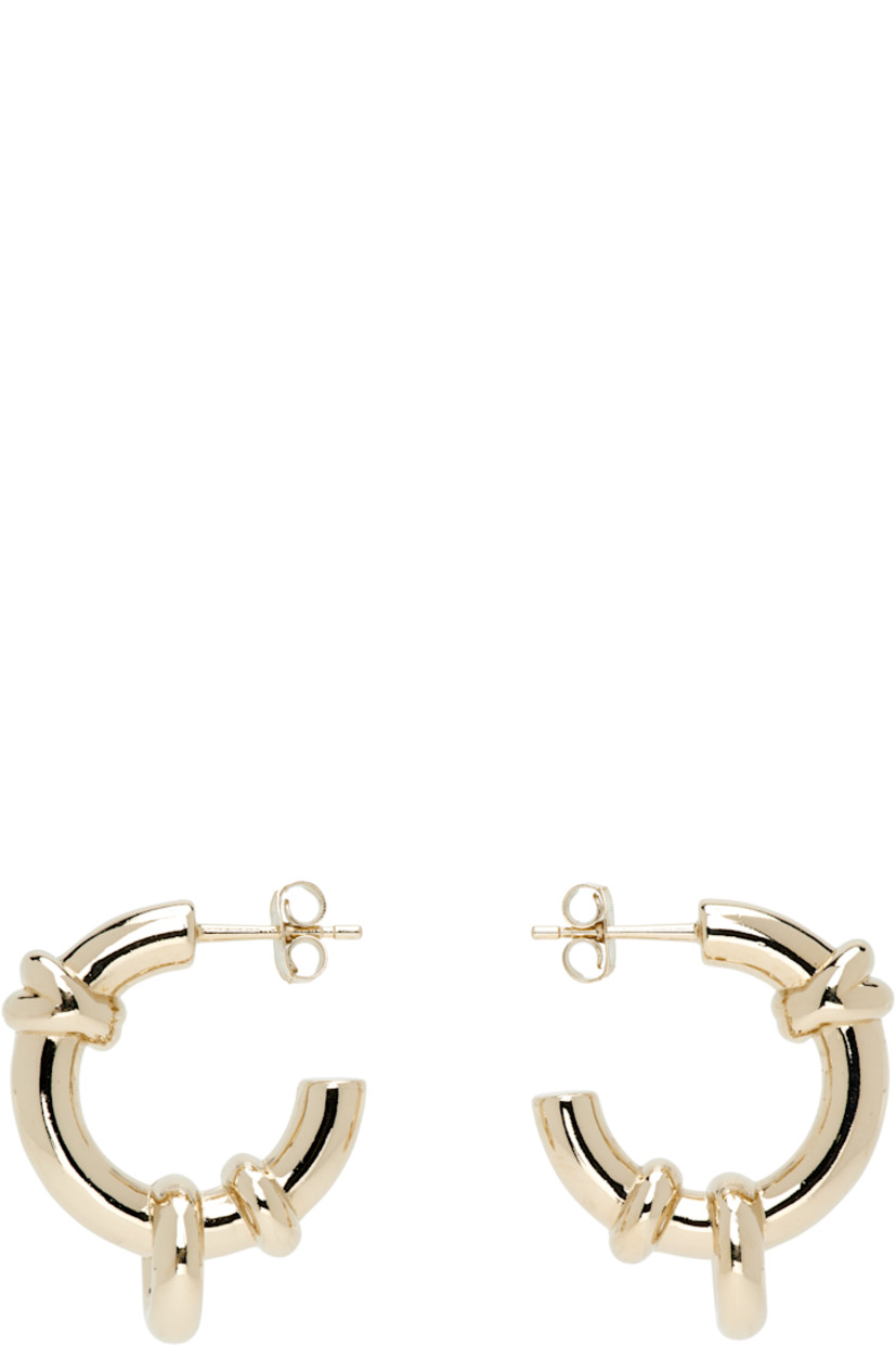 Pair of handcrafted open hoop earrings in 24k gold-plated brass.

· O-rings at hoop
· Post-stud fastening 
�· D1"

Supplier color: Gold