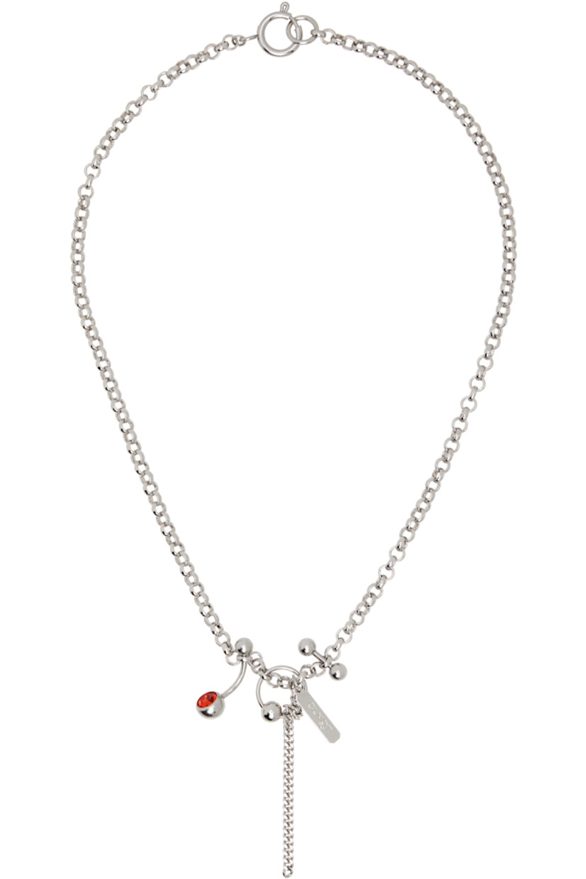Handcrafted rolo chain necklace in palladium-plated brass. 

· Charms, logo plaque, and red crystal at drop
· Spring-ring fastening 
· L17.5"

Supplier color: Palladium