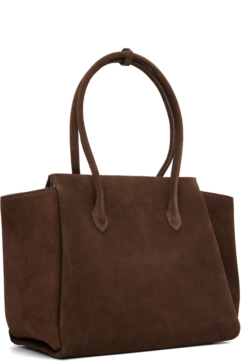 Calfskin suede carryall tote.

· Post-stud tab at rolled shoulder straps
· Logo embossed at face
· Bumper studs at base
· Magnetic closure
· Patch pocket at interior
· Faille lining
· H11.25" x W18" x D7"

Supplier color: Suede cocoa
