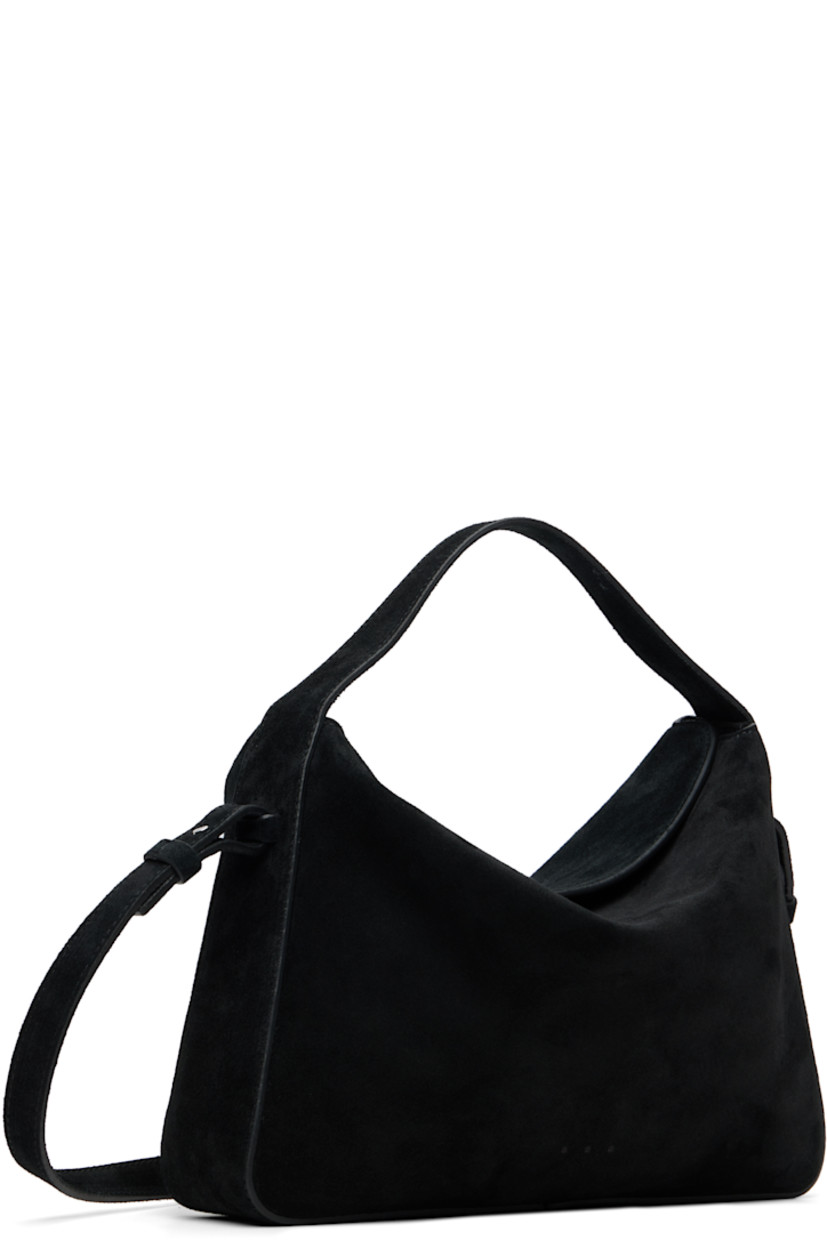 Calfskin suede shoulder bag.

· Fixed carry handle
· Detachable crossbody strap
· Logo embossed at face
· Magnetic flap
· Card slot at interior
· Faille lining
· H7" x W10.25" x D2.5"

Supplier color: Suede black