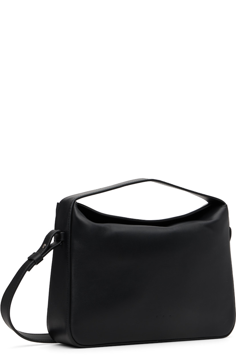 Buffed calfskin shoulder bag.

· Fixed carry handle
· Detachable crossbody strap
· Logo embossed at face
· Magnetic foldover closure
· Patch pocket at interior
· Faille lining
· H7" x W10.25" x D2.5"

Supplier color: Black