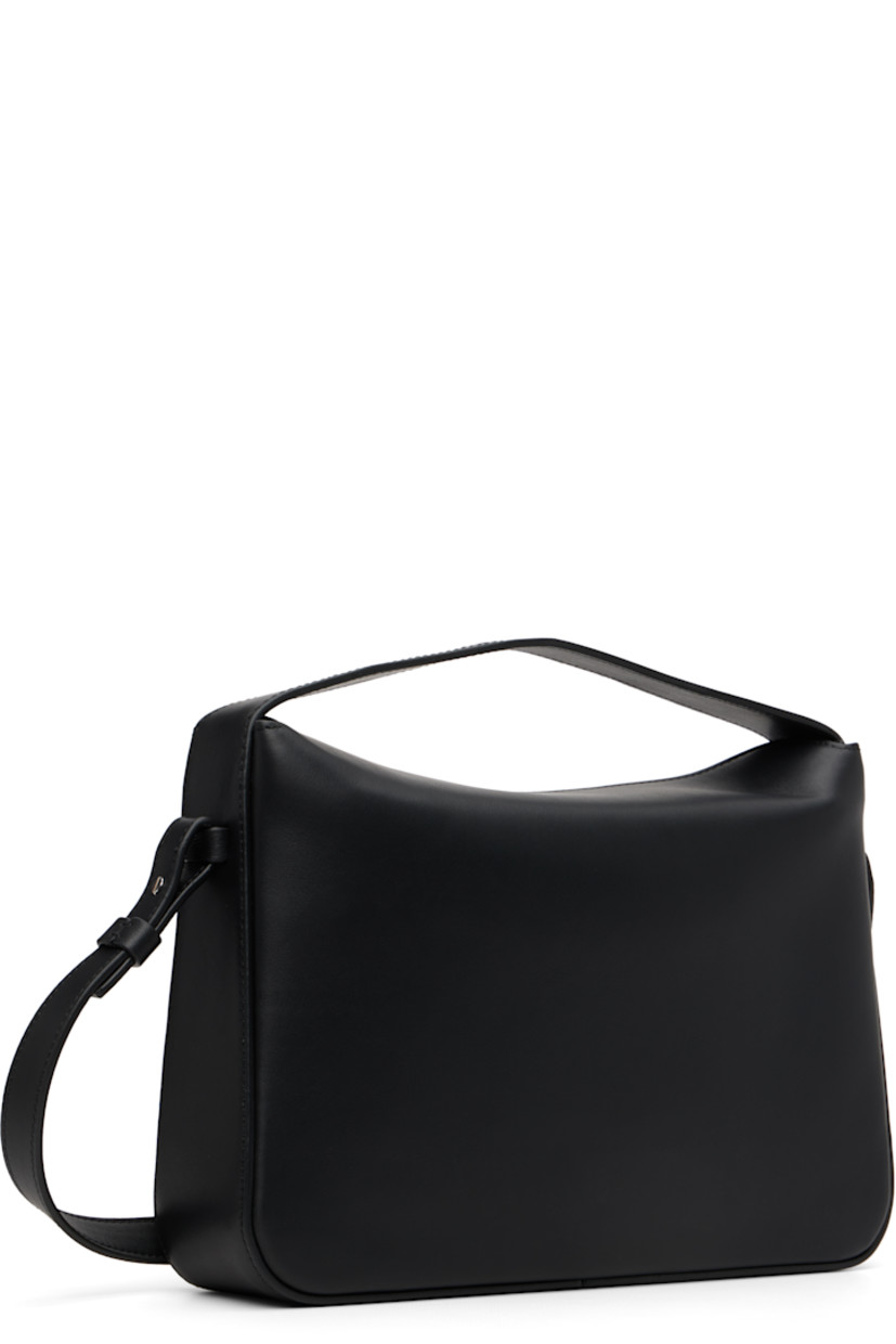 Buffed calfskin shoulder bag.

· Fixed carry handle
· Detachable crossbody strap
· Logo embossed at face
· Magnetic foldover closure
· Patch pocket at interior
· Faille lining
· H7" x W10.25" x D2.5"

Supplier color: Black