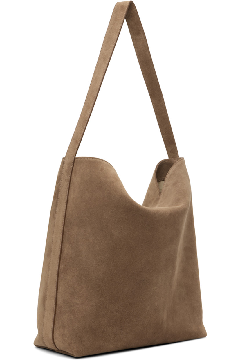 Calfskin suede tote.

· Fixed shoulder strap
· Logo embossed at face
· Magnetic closure
· Patch pocket at interior
· Faille lining
· H13.75" x W16" x D5.25"

Supplier color: Suede date