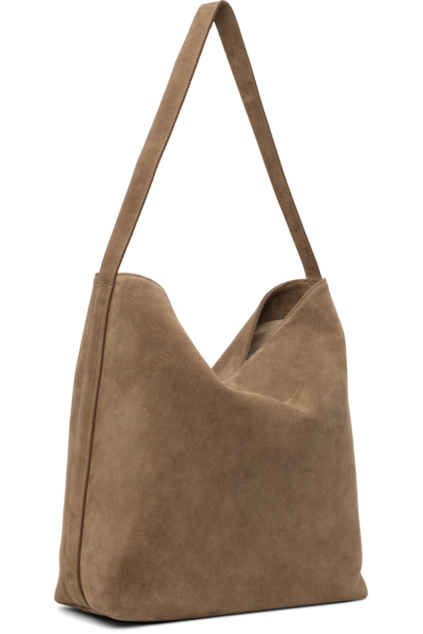 Calfskin suede tote.

· Fixed shoulder strap
· Logo embossed at face
· Magnetic closure
· Patch pocket at interior
· Faille lining
· H13.75" x W16" x D5.25"

Supplier color: Suede date