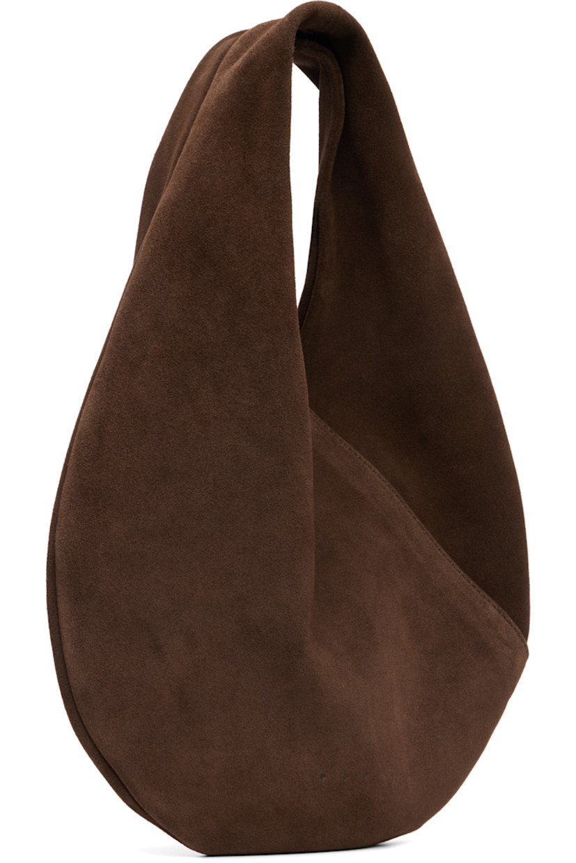 Calfskin suede shoulder bag.

· Integrated shoulder strap
· Logo embossed at face
· Magnetic closure
· Unlined
· H9.5" x W10" 
· Total height: H13"

Supplier color: Suede cocoa