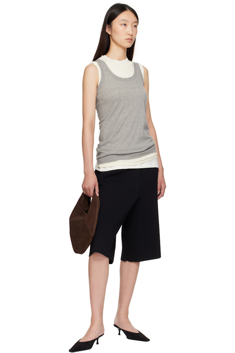 Calfskin suede shoulder bag.

· Integrated shoulder strap
· Logo embossed at face
· Magnetic closure
· Unlined
· H9.5" x W10" 
· Total height: H13"

Supplier color: Suede cocoa