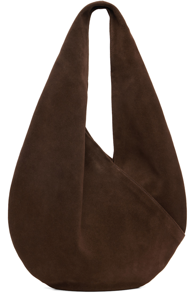 Calfskin suede shoulder bag.

· Integrated shoulder strap
· Logo embossed at face
· Magnetic closure
· Unlined
· H10.5" x W14.5" 
· Total height: H18.5"

Supplier color: Suede cocoa