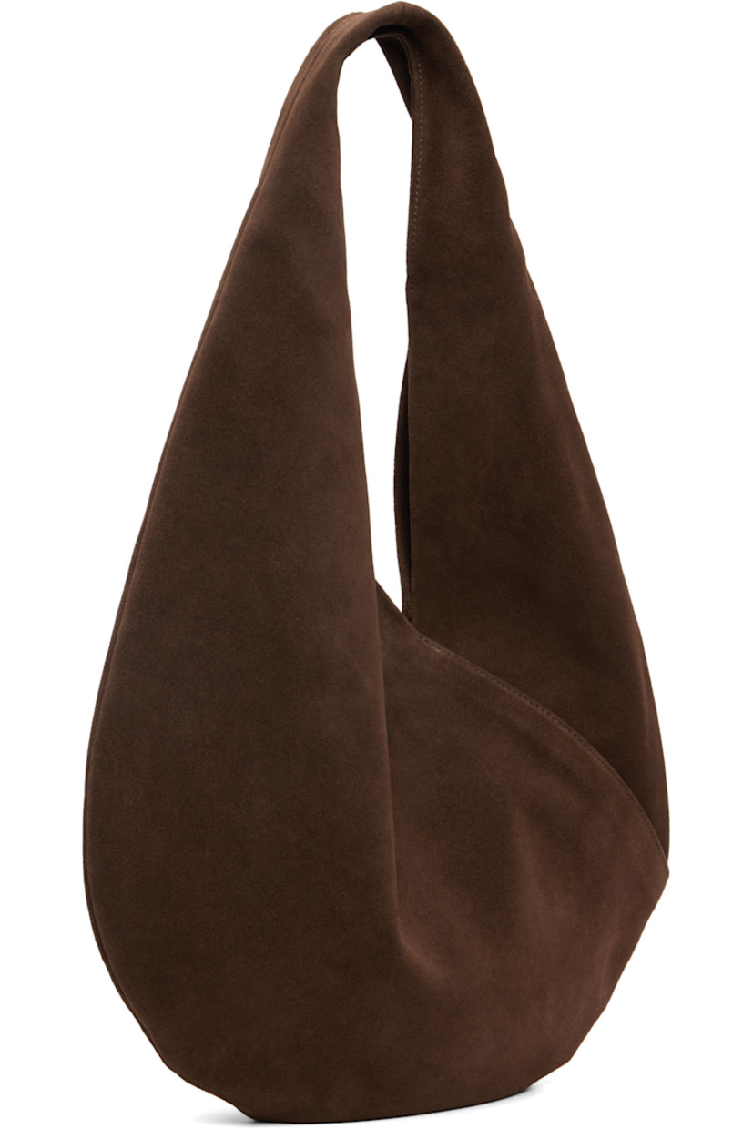 Calfskin suede shoulder bag.

· Integrated shoulder strap
· Logo embossed at face
· Magnetic closure
· Unlined
· H10.5" x W14.5" 
· Total height: H18.5"

Supplier color: Suede cocoa