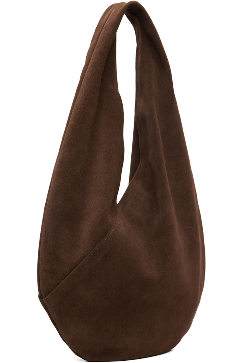 Calfskin suede shoulder bag.

· Integrated shoulder strap
· Logo embossed at face
· Magnetic closure
· Unlined
· H10.5" x W14.5" 
· Total height: H18.5"

Supplier color: Suede cocoa