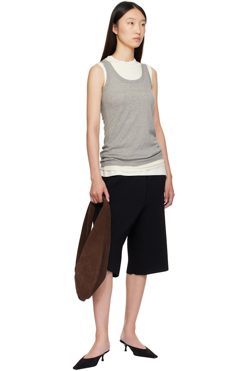 Calfskin suede shoulder bag.

· Integrated shoulder strap
· Logo embossed at face
· Magnetic closure
· Unlined
· H10.5" x W14.5" 
· Total height: H18.5"

Supplier color: Suede cocoa