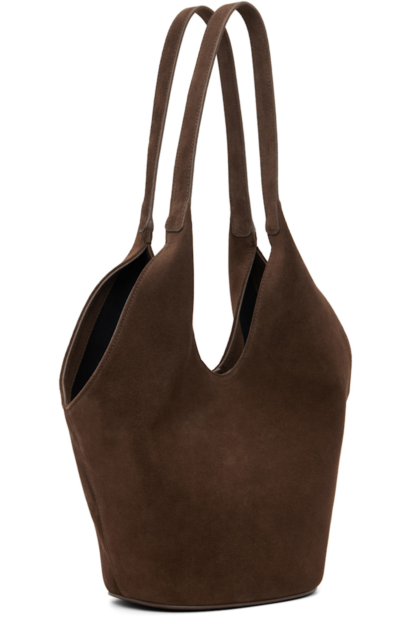 Calfskin suede tote.

· Fixed shoulder straps
· Logo embossed at face
· Magnetic closure
· Card slot at interior
· Faille lining
· H13" x W14" x D5.5"

Available exclusively at SSENSE.

Supplier color: Suede cocoa