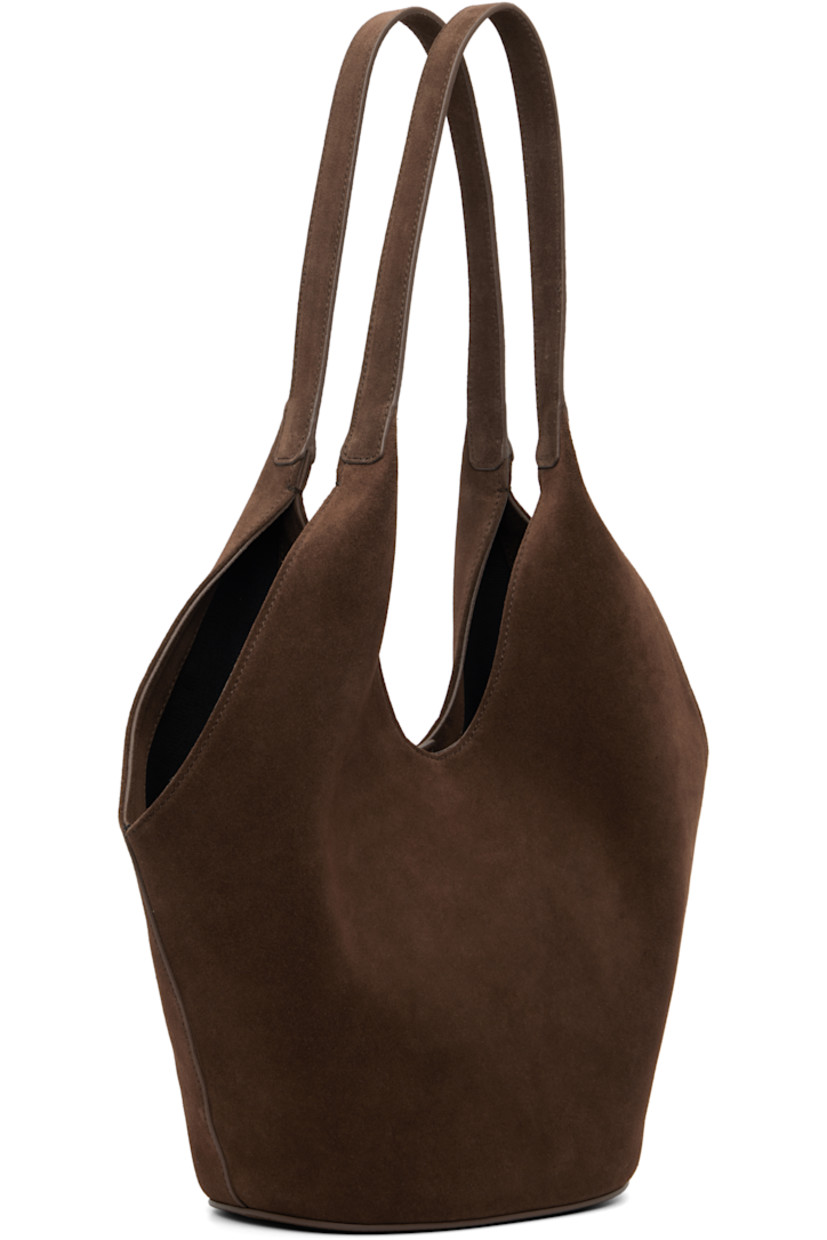 Calfskin suede tote.

· Fixed shoulder straps
· Logo embossed at face
· Magnetic closure
· Card slot at interior
· Faille lining
· H13" x W14" x D5.5"

Available exclusively at SSENSE.

Supplier color: Suede cocoa