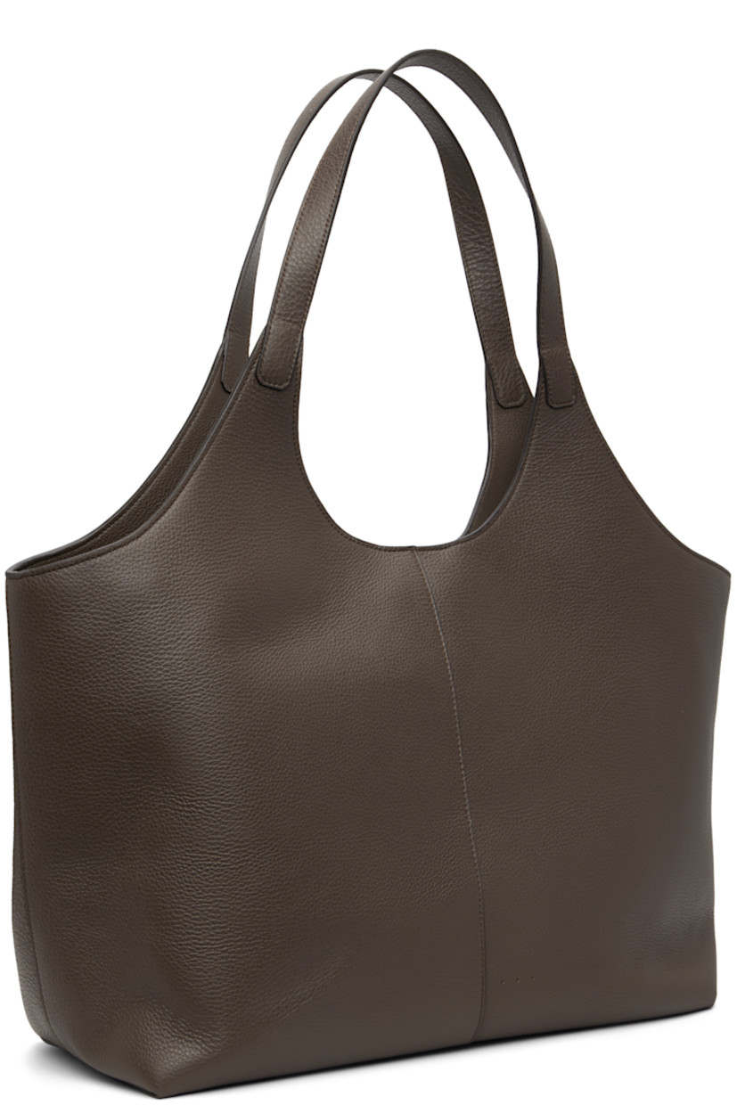 Pebble-grained calfskin tote.

· Fixed shoulder straps
· Logo embossed at face
· Magnetic closure
· Patch pocket at interior
· Faille lining
· H11.75" x W21" x D6"

Supplier color: Grain chestnut