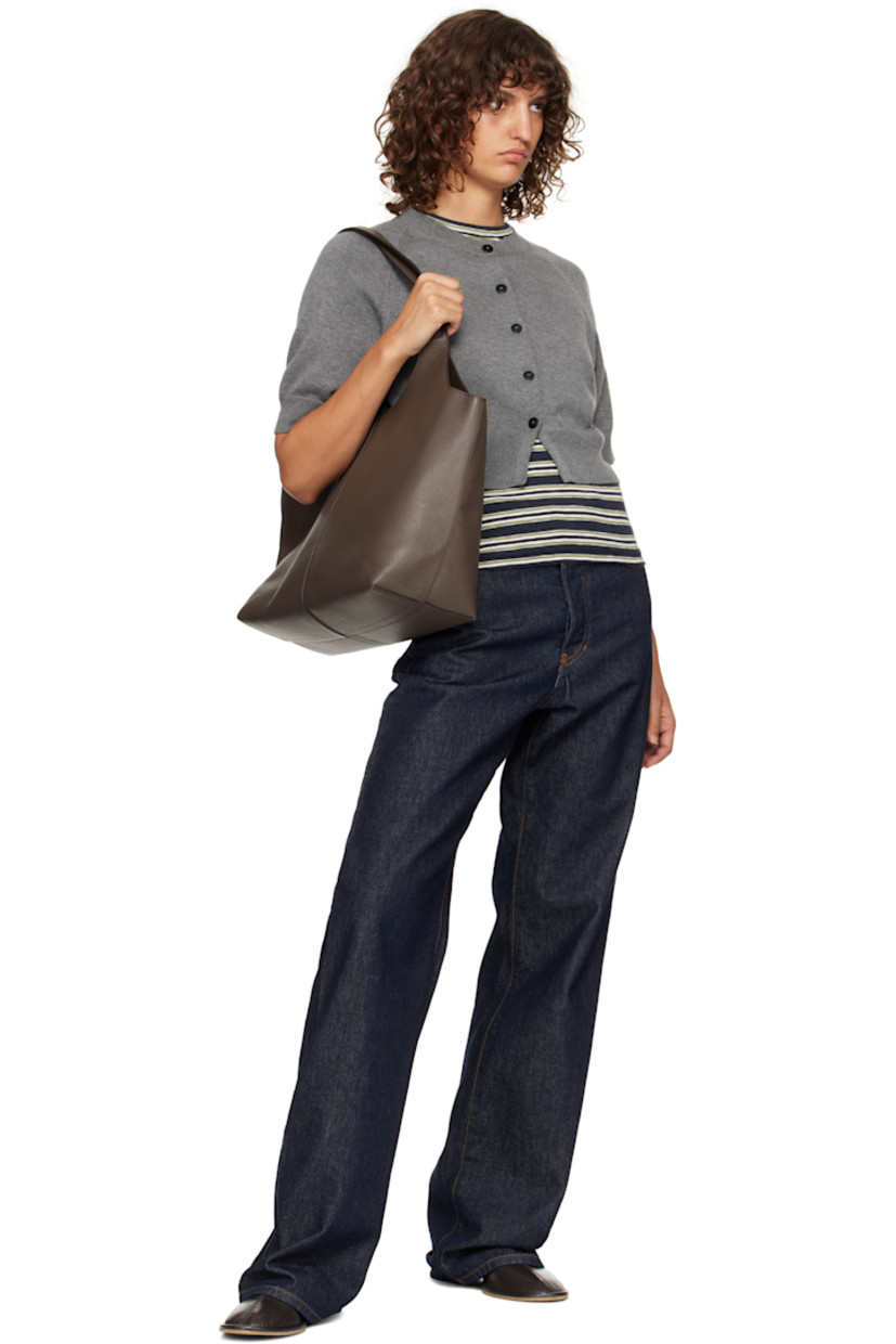 Pebble-grained calfskin tote.

· Fixed shoulder straps
· Logo embossed at face
· Magnetic closure
· Patch pocket at interior
· Faille lining
· H11.75" x W21" x D6"

Supplier color: Grain chestnut