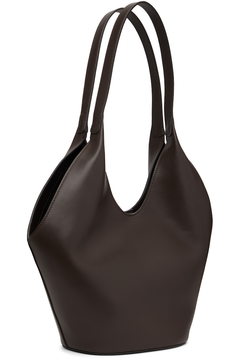 Grained calfskin tote. 

· Integrated shoulder straps
· Logo embossed at face
· Magnetic closure
· Card slot at interior 
· Faille lining
· H9" x W14.5" x D5.5"
· Total height: H20"

Available exclusively at SSENSE.

Supplier color: Tobacco